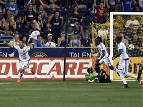 Montreal Impact's Matteo Mancosu (21) celebrates after he scores a goal against Philadelphia Union goalkeeper Andre Blake (1) and Warren Crevalle (2) in the second half of an MLS soccer match on Saturday, Sept. 10, 2016, in Chester, Pa. The match ended in a 1-1 tie.