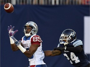 Montreal Alouettes' Duron Carter (89) intercepts the ball as Toronto Argonauts' A.J. Jefferson gives chase during first half CFL action in Toronto, Monday, July 25, 2016.
