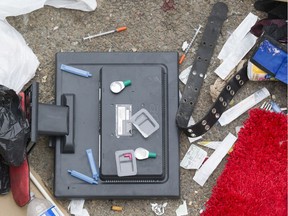 Syringes and other items are scattered beside a makeshift shelter at Viger Park. Advocates say supervised drug injection sites help neighbourhoods by reducing consumption in public spaces.