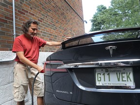 Jean-Francois Barsoum charges his Tesla in the driveway of his home in Outremont. (Marie-France Coallier/ MONTREAL GAZETTE)
