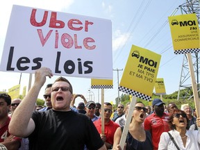 Taxi drivers protest against Uber and other alternate transportation services during a demonstration in Montreal, Tuesday, Aug. 25, 2015.