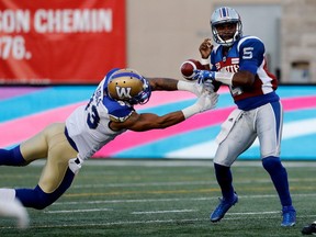 Former Alouettes quarterback Kevin Glenn has the ball stripped from his hands by Winnipeg Blue Bombers defensive-lineman Justin Cole during CFL action at Molson Stadium in Montreal on Friday August 26, 2016.