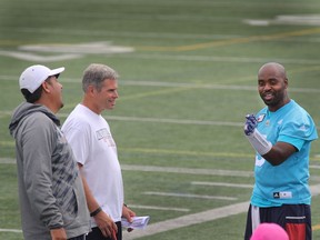 Montreal Alouettes offensive coordinator and quarterbacks coach Anthony Calvillo, far left, and Jacques Chapdelaine, wide receivers coach, middle, are all smiles while listening to quaterback, Kevin Glenn on August 30, 2016, during the team final practice of the week at Stade Hébert .They prepare themselves for Thursday's home game against the Ottawa Redblacks.Herb Zerkowsky reports on how the team will adjust to receiver Deron Carter's recent suspension.Marie-France Coallier/ MONTREAL GAZETTE)  ORG XMIT: 56995