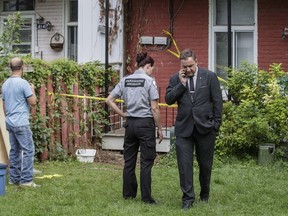 Verdun Mayor Jean-François Parenteau, right, makes a call at the location where an escaped python hid under a home located on Willibrord street in Verdun in Montreal on Wednesday, August 31, 2016.