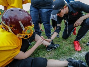 Cousins Eddy Tibbo, seen here, and Victoria Tibbo coach the Aces atom football team in Montreal, on Thursday, September 1, 2016. The team is running a crowdfunding campaign to raise money for a team bus.