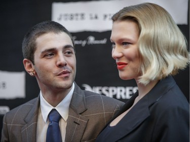 Director Xavier Dolan, left, and actor Léa Seydoux, right, pose for photos on the red carpet before the Montreal premiere of their film Juste la fin du monde (It's Only the End of the World) at the Théâtre Outremont in Montreal on Monday, September 12, 2016.