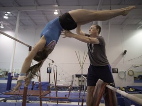 New owner and coach Claude Pelletier instructs Gabrielle Deslauriers as she goes through uneven parallel bars exercises at WIMGYM in Dorval on Monday, September 12, 2016. (Peter McCabe / MONTREAL GAZETTE)