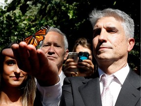 Nelson De Sousa releases a butterfly during the ceremonies to mark the 10th anniversary of the Dawson College shootings in Montreal on Tuesday, Sept. 13, 2016.