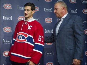 Montreal Canadiens head coach Michel Therrien walks behind new team captain Max Pacioretty after a news conference at the Bell Sports Complex in Brossard near Montreal Friday, September 18, 2015.