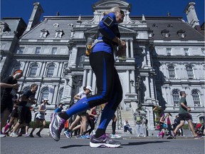 Don't get caught up in the excitement of those early miles and go out too hard. Pictured: Runners passing Montreal city hall in last year's marathon.