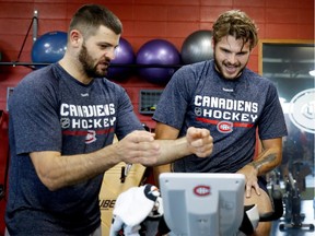 Montreal Canadiens centre Alex Galchenyuk, right, strains during an endurance test as Alexander Radulov encourages him at training camp in Brossard on Thursday September 22, 2016.