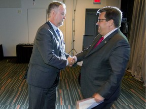 Montreal inspector general Denis Gallant, left, thanks Montreal Mayor Denis Coderre for introducing him at a conference of inspectors general from across North America, at the Palais des congrès in Montreal, Thursday Sept. 22, 2016.