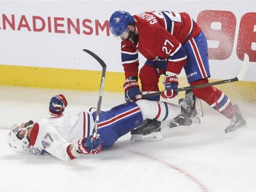 Alexander Radulov hits the ice hard at the end of a hit by Alex Galchenyuk during a Red vs. White scrimmage with Montreal Canadiens players at the Bell Centre in Montreal Sunday, September 25, 2016.