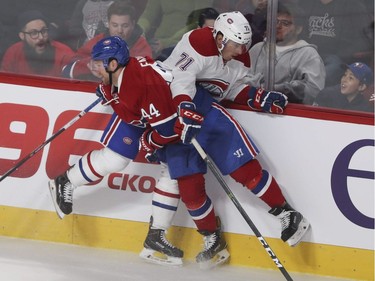 Forward Bobby Farnham (left) checks defenseman Joel Hanley during a Red vs. White scrimmage with Montreal Canadiens players at the Bell Centre in Montreal Sunday, September 25, 2016.