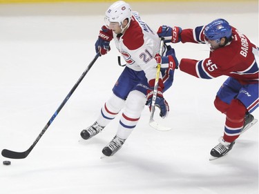 Forward Stefan Matteau receives pressure from defenseman Mark Barber during a Red vs. White scrimmage with Montreal Canadiens players at the Bell Centre in Montreal Sunday, September 25, 2016.