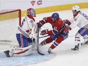 Paul Byron crowds goalie Al Montoya while under pressure from defenceman Ryan Johnston during a Red vs. White scrimmage with Montreal Canadiens players at the Bell Centre on Sunday, Sept. 25, 2016.