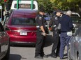 Montreal Taxi Bureau inspectors speak to an Uber driver after seizing his car on Berri St. in Montreal, Monday, Sept. 26, 2016.  Uber has challenged all the car seizures in Montreal Municipal Court.