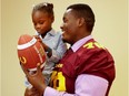 Concordia Stingers offensive-guard Maurice Simba talks football with 6 year old Shriner's Hospital patient Rachel-Ann Brice during a news conference announcing the 30th edition of the Canada Shrine Bowl in Montreal on Wednesday September 28, 2016.