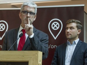 Former PQ MNAs Jean-Martin Aussant, left, speaks as former student leader Gabriel Nadeau-Dubois listens, at a launch of new non-partisan political entity called Faut qu'on se parle, in Montreal.  Others in the group include Claire Bolduc, Maïtée Labrecque-Saganash and Alain Vadeboncœur.