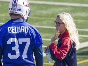 Montreal Alouettes' Catherine Raiche, who is the team's co-ordinator of football administration, speaks with Martin Bedard during Alouettes practice on Wednesday September 28, 2016. (Pierre Obendrauf / MONTREAL GAZETTE) ORG XMIT: 57195 - 0151