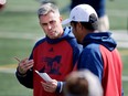 Montreal Alouettes head coach Jacques Chapdelaine, left, speaks with quarterbacks coach Anthony Calvillo during a team practice in Montreal on Friday Sept. 30, 2016.