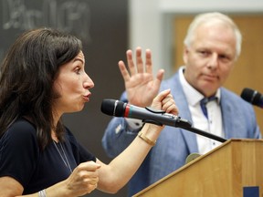 Jean-François Lisée tries to interrupt Martine Ouellet during a Parti Québécois leadership debate at Université de Montréal on Sept. 6. Ouellet is accusing the party "establishment" of trying to muzzle her.