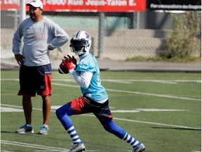 Montreal Alouettes quarterback Rakeem Cato prepares to throw the ball as offensive coordinator, quarterbacks coach Anthony Cavillo looks on during a team practice in Montreal on Wednesday September 7, 2016.