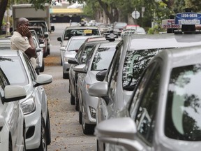 Cab driver Jordenne Evens stands beside a line of cabs outside  the headquarters of RTAM-Métallos (organization representing Montreal taxi drivers) in Montreal Thursday, September 8, 2016. RTAM-Métallos and cab drivers reacted to the deal struck late Wednesday between Uber and the Quebec government. (John Kenney / MONTREAL GAZETTE)