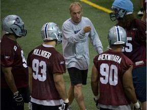 Jeff Reinebold (centre) gives instructions during first day of Alouettes training camp at Centre Multisport Roland-Dussault in Sherbrooke Quebec Sunday, June 3, 2012.