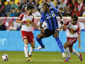 New York Red Bulls midfielder Felipe Martins (8) and Montreal Impact forward Didier Drogba (11) and New York Red Bulls midfielder Salvatore Zizzo (15) battle for the ball during first half at Red Bull Arena on Saturday, Sept. 24, 2016.