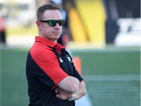 Ottawa Redblacks assistant GM Brock Sunderland watches from the sidelines during CFL game.