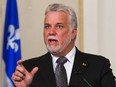 Quebec Premier Philippe Couillard gestures during a news conference after a cabinet shuffle at the legislature in Quebec City on Saturday, August 20, 2016.