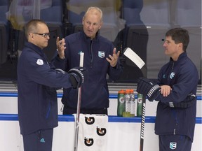 Team Europe head coach Ralph Krueger, centre, chats with assistant coaches Paul Maurice, left, and Brad Shaw during the first practice session in preparation for the World Cup of Hockey tournament, Monday, September 5, 2016 at the Vidéotron Centre in Quebec City.