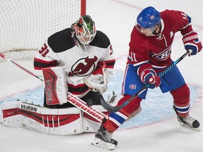 Montreal Canadiens' Brendan Gallagher (11) moves in on New Jersey Devils goalie Scott Wedgewood during first period NHL pre-season hockey action in Montreal, Monday, September 26, 2016.