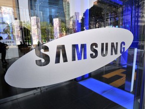 In a file photo taken on April 27, 2012 a logo of Samsung is displayed on the glass door of its showroom in Seoul.