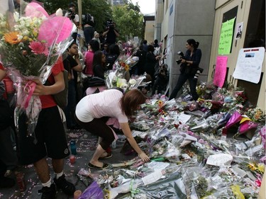 Students return to remove a wall of flowers and re-enter Dawson College, Sept. 18, 2006. It was the first time students entered the building since the shooting rampage five days earlier.