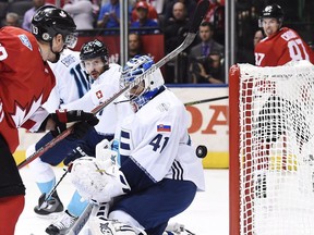 Team Canada's Patrice Bergeron (37), not shown, scores on Team Europe goalie Jaroslav Halak (41) as Canada's Brad Marchand (63) and Sidney Crosby (87) look on during third period World Cup of Hockey finals action in Toronto on Tuesday, September 27, 2016.
