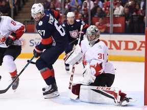 Team USA's Max Pacioretty, left, stands in front of Team Canada goalie Carey Price as he makes a save during second period World Cup of Hockey action in Toronto on Tuesday, September 20, 2016.