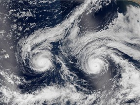 It looks like an angry face, but really this NASA satellite image taken Aug. 29, 2016, shows Hurricane Madeline, left, and Hurricane Lester over the Pacific Ocean in a composite built from two overpasses by the Visible Infrared Imaging Radiometer Suite on the Suomi NPP satellite.