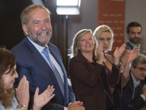 Leader Tom Mulcair is applauded at the beginning of an NDP caucus meeting Sept. 14, 2016, in Montreal.
