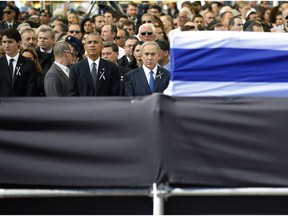 U.S. President Barack Obama, centre left, stands alongside Israeli Prime Minister Benjamin Netanyahu, centre right, before the flag draped coffin of former Israeli President Shimon Peres, 93, during his state funeral on Mt. Herzl Military Cemetery in Jerusalem, Friday, Sept. 30, 2016. At left is Canadian Prime Minister Justin Trudeau.