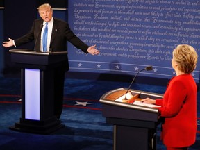 Republican nominee Donald Trump (L) and Democratic nominee Hillary Clinton (R) exchanges during the first presidential debate at Hofstra University in Hempstead, New York on September 26, 2016. Hillary Clinton and Donald Trump face off in one of the most consequential presidential debates in modern US history with up to 100 million viewers set to tune in.