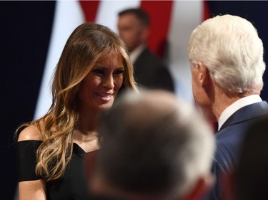 Bill Clinton (R) shakes hands with  Melania Trump during the first presidential debate at Hofstra University in Hempstead, New York on September 26, 2016.