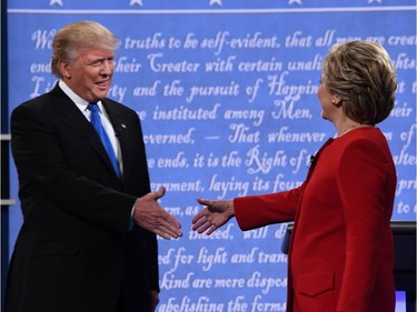 Democratic nominee Hillary Clinton (R) shakes hands with Republican nominee Donald Trump during the first presidential debate at Hofstra University in Hempstead, New York on September 26, 2016.