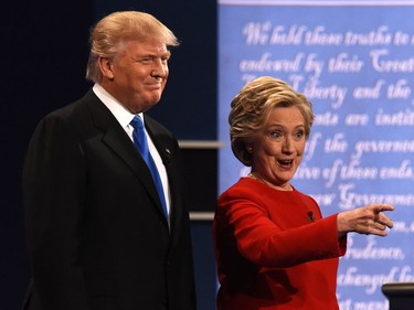 Democratic nominee Hillary Clinton (R) gestures next to Republican nominee Donald Trump during the first presidential debate at Hofstra University in Hempstead, New York on September 26, 2016.