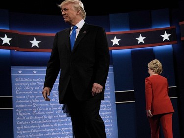 Republican presidential nominee Donald Trump (L) and Democratic presidential nominee Hillary Clinton walk to their lectures for the first US Presidential Debate at Hofstra University September 26, 2016 in Hempstead, New York.