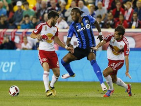 New York Red Bulls midfielder Felipe Martins (8) and Montreal Impact forward Didier Drogba (11) and New York Red Bulls midfielder Salvatore Zizzo (15) battle for the ball  during first half at Red Bull Arena on Saturday, Sept. 24, 2016.
