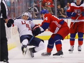 Roman Polak (#64) of Team Czech Republic checks Zach Parise (#9) of Team USA during the third period at the World Cup of Hockey tournament at the Air Canada Centre on September 22, 2016 in Toronto, Canada.