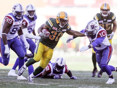 Edmonton Eskimos' John White pushes away Montreal Alouettes' Marc-Olivier Brouillette during CFL action at Molson Stadium in Montreal on Monday, Oct. 10, 2016.