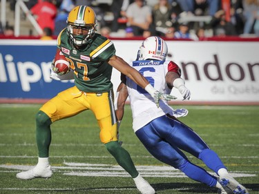 Edmonton Eskimos' Derel Walker sidesteps a tackle by Montreal Alouettes' Ramon Taylor during CFL action at Molson Stadium in Montreal on Monday, Oct. 10, 2016.